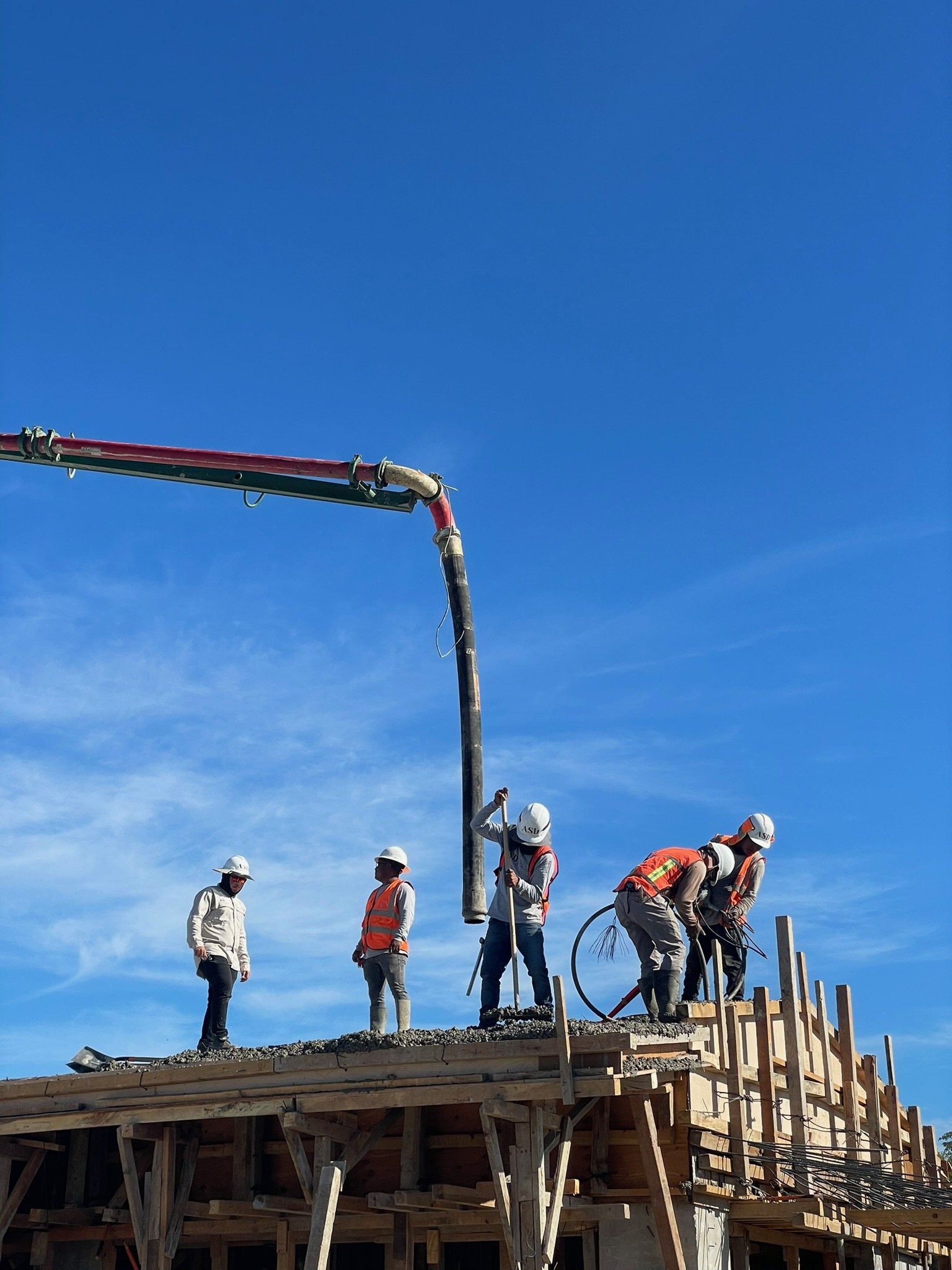 Crew placing a concrete slab pour