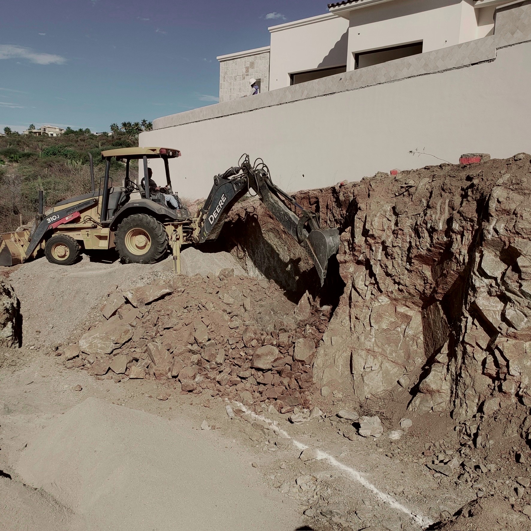 Excavator preparing a building pad