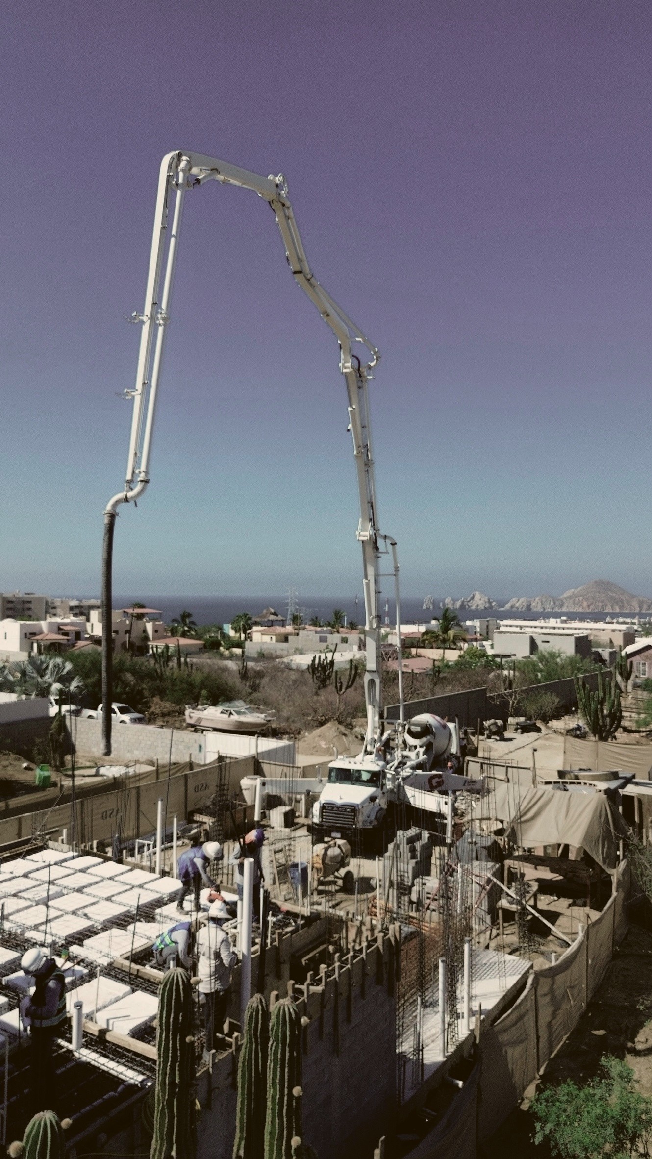 Concrete pump boom against a clear sky