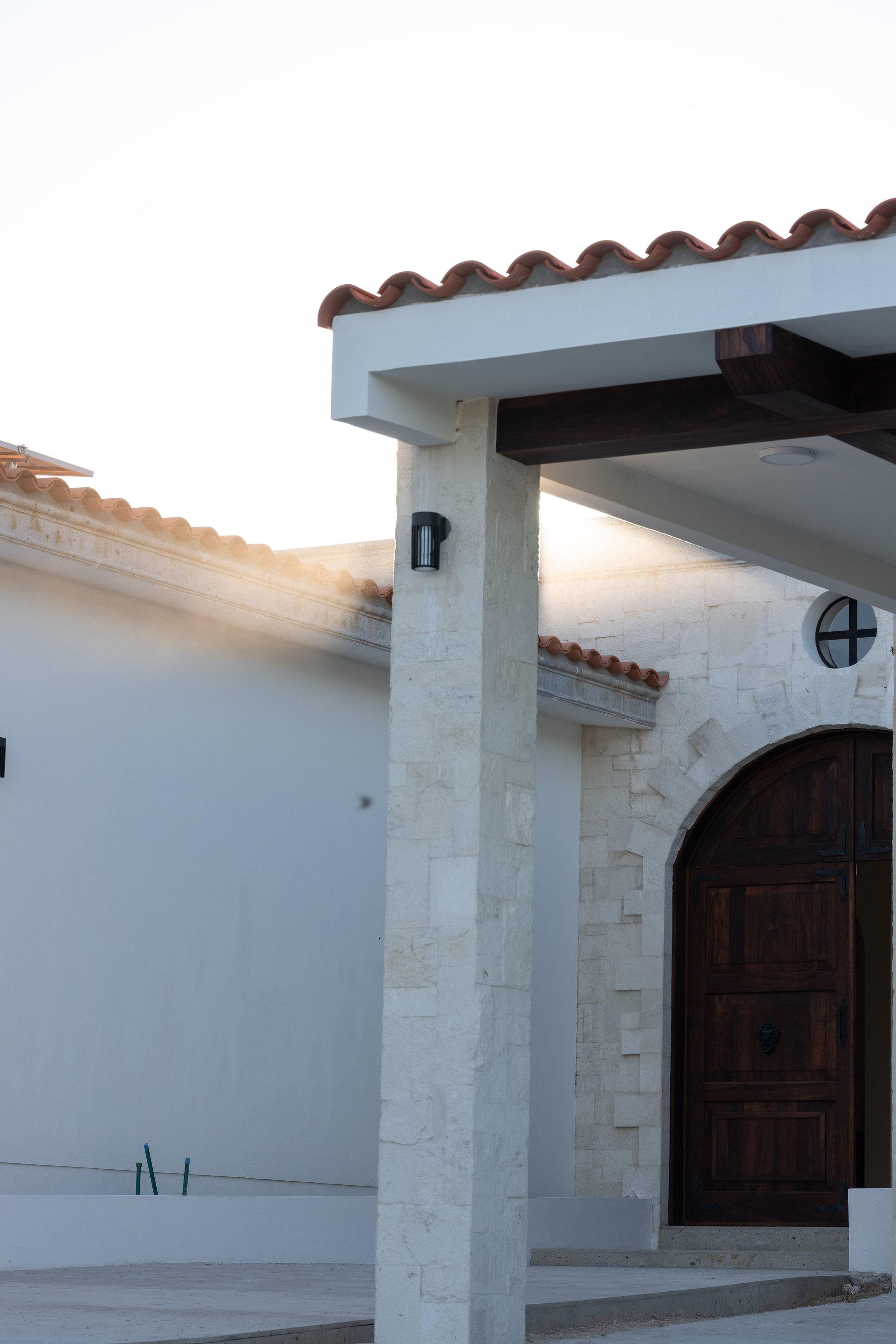 Stone facade with arched wood door